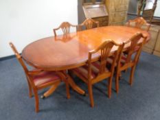 A yewwood extending dining table with leaf together with a set of six dining chairs