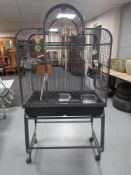 A metal bird cage on stand