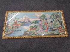 A needle work picture depicting Geishas in a gilt frame