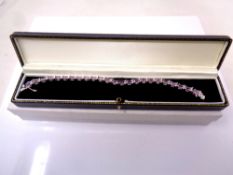 A silver tennis bracelet.