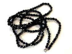 A black glass facet cut necklace.