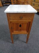 An Edwardian inlaid oak marble topped pot cupboard