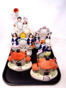 A tray containing a pair of Staffordshire houses together with four further Staffordshire flat