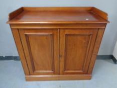 A Victorian mahogany double door cupboard with gallery