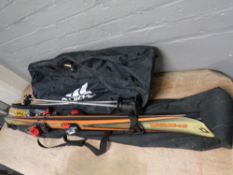 A pair of Syntro skies in carry bag with ski poles