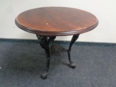 A pine circular pub table on cast iron base