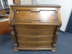 A continental carved oak bowfront bureau