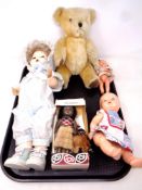 A tray containing a Dean's Toys mohair teddy bear together with four 20th century dolls