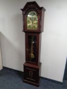 A contemporary longcase clock with brass moonphase dial with pendulum and weights