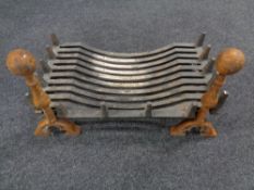 A 19th century cast iron fire grate together with a pair of fire dogs