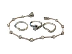 Three 9ct white gold diamond set rings, together with a silver bracelet.