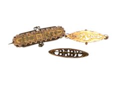 An antique gold 'baby' brooch together with two further similar brooches, 6.35g.