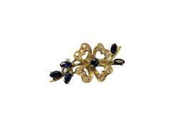 An 18ct gold diamond and sapphire brooch, 7.2g, width 38 mm.