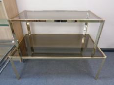 Two graduated brass framed coffee tables with smoked glass tops