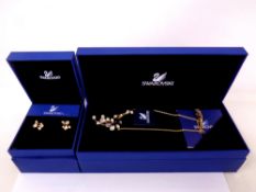 A Swarovski crystal pendant on chain with matching earrings,
