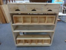 A set of stripped pine open shelves,