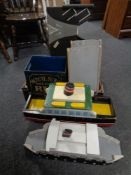 Two wooden hand built ferries with landing ramps and a painted crate 