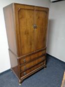A 20th century walnut double door hanging linen cabinet