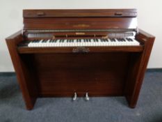 An Eavestaff Pianette mini piano with storage piano stool