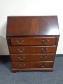 A mahogany bureau fitted with four drawers