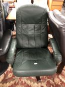A 20th century Danish green leather manual reclining swivel armchair