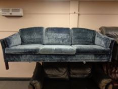 A mid 20th century Danish blue velvet-like fabric three seater settee
