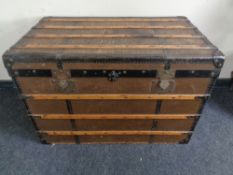 An early 20th century wooden bound shipping trunk