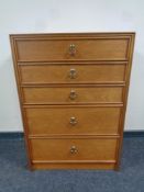 A mid 20th century five drawer teak effect chest