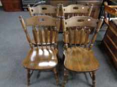 A set of four stained beech kitchen chairs