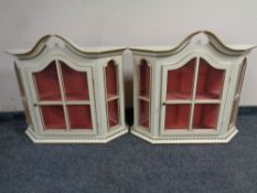 A pair of cream and gilt wall cabinets