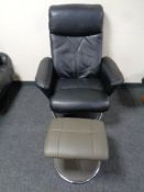 A black leather high backed manual reclining swivel armchair on chrome metal base and a similar