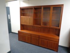 A mid 20th century cocktail display unit fitted with cupboards and drawers beneath