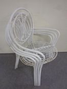 A set of four metal stacking garden armchairs