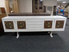 A 20th century Scandinavian painted four door sideboard on raised legs