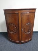 An Eastern hardwood double door corner cabinet