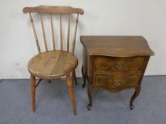 A carved beech two drawer chest and a kitchen chair