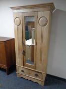 An Edwardian satinwood mirror door wardrobe
