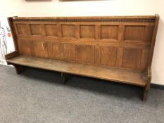 An oak high backed church pew,
