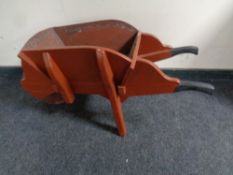 A wooden garden wheel barrow planter