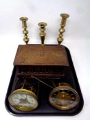 A tray of three 19th century brass candlesticks,