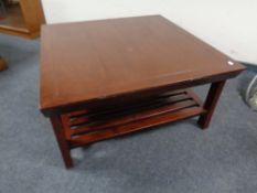 A contemporary square coffee table with under shelf