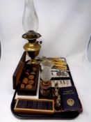 A tray containing cased plated spoons and sugar tongs, fish cutlery, Chinese brass figures,