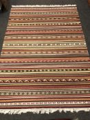 A flatweave kilim on polychrome ground, 206 cm x 147 cm.
