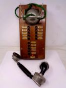 An early 20th century wall mounted telephone with switch box