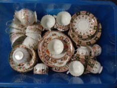 A box containing antique china tea services
