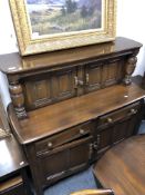 An Ercol elm and beech buffet backed sideboard