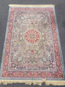 A machine made rug of Isfahan design on blue ground 181 cm x 117 cm