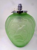 An Art Deco green glass table lamp, the shade depicting a bird in flight amongst bulrushes.