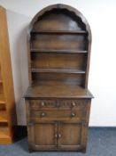An oak dome topped dresser fitted cupboards and drawers beneath
