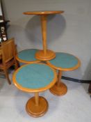 A set of four pedestal bistro tables